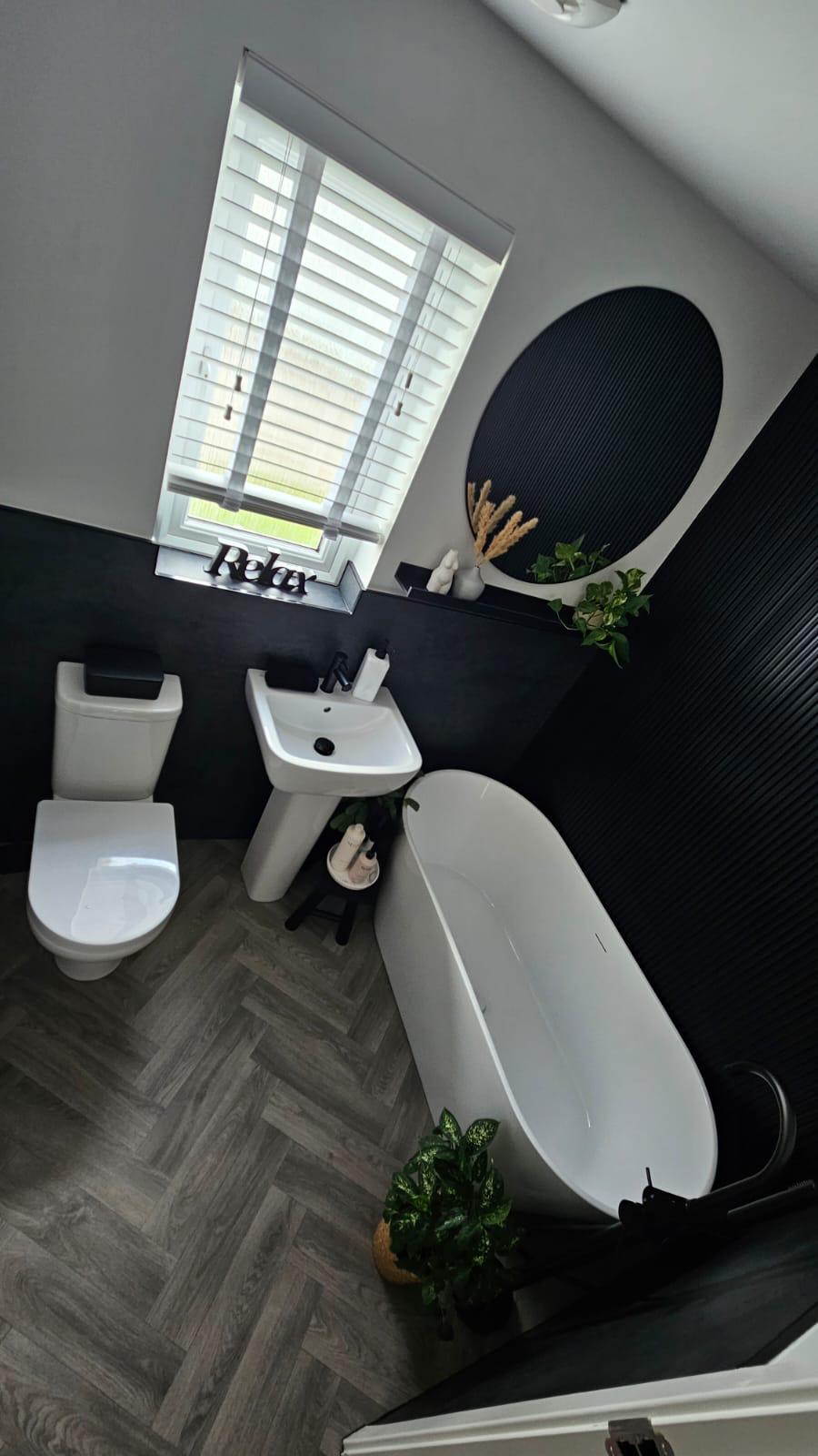 Fitted bathroom with freestanding bath, pedestal basin and WC